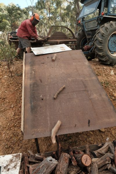 Firewood processing Seasoned firewood docking on PTO driven saw bench